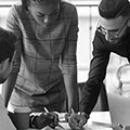 Three people looking at a paper on a table